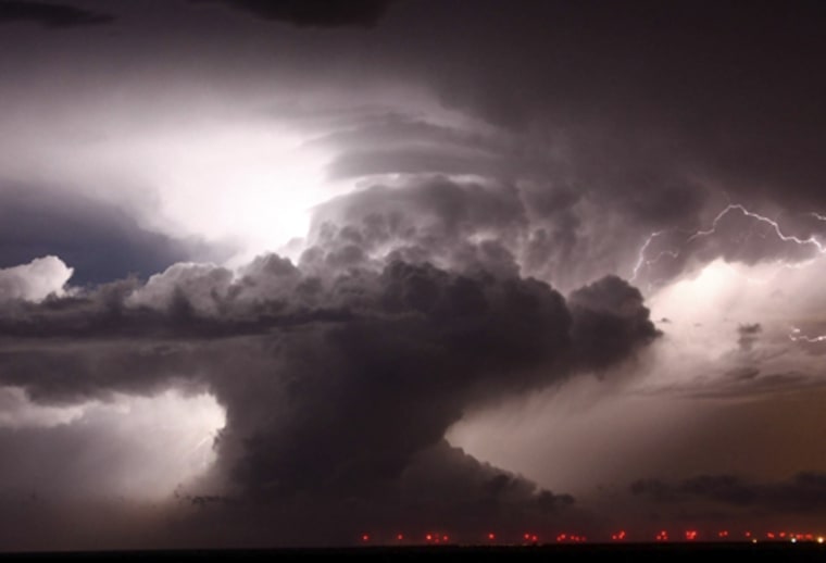 A supercell that became a Tornadic vortex signature lights up the night sky with lightning over Amarillo